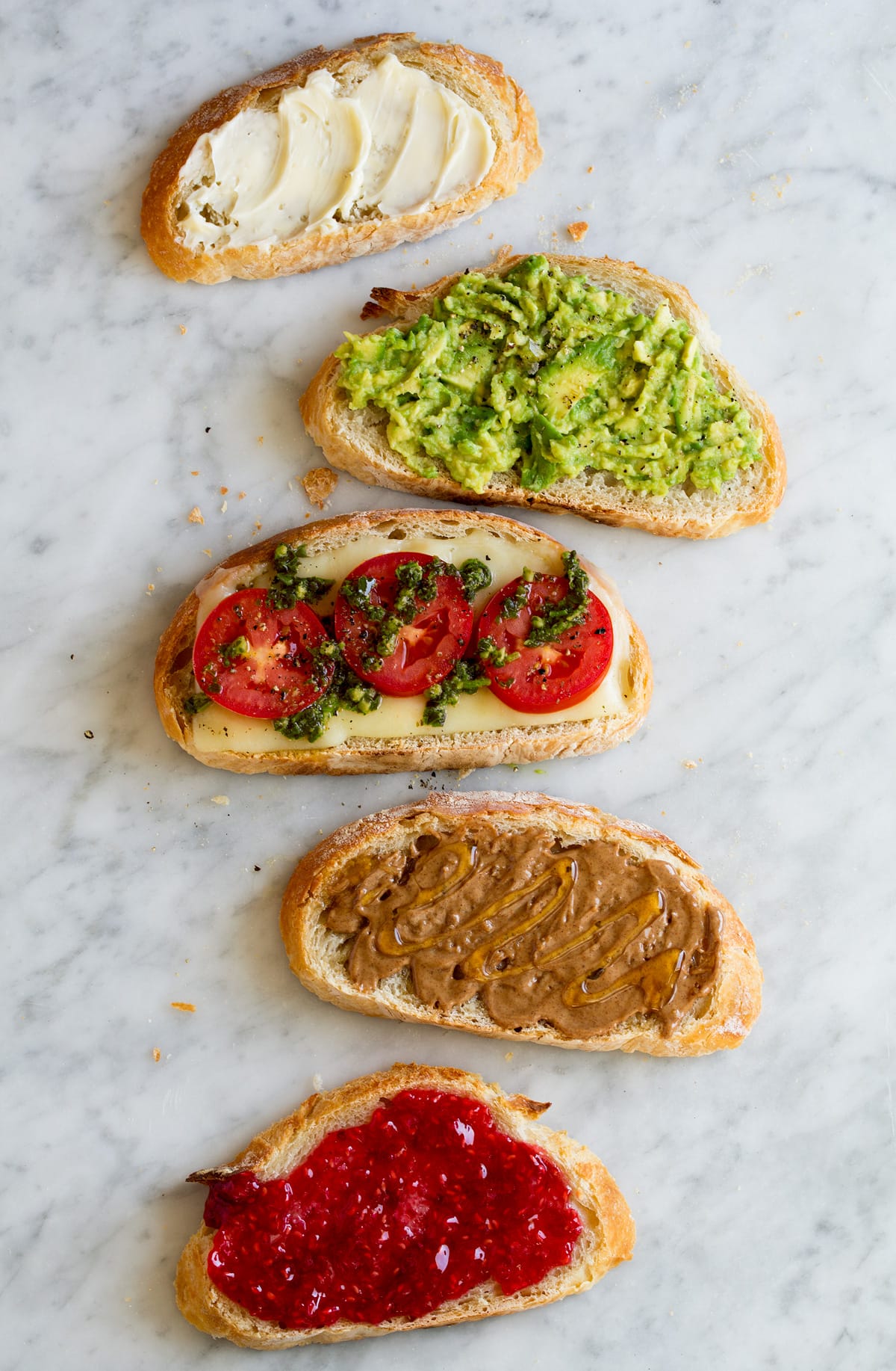 No Knead Bread Different toppings ideas shown on slices of no knead bread.