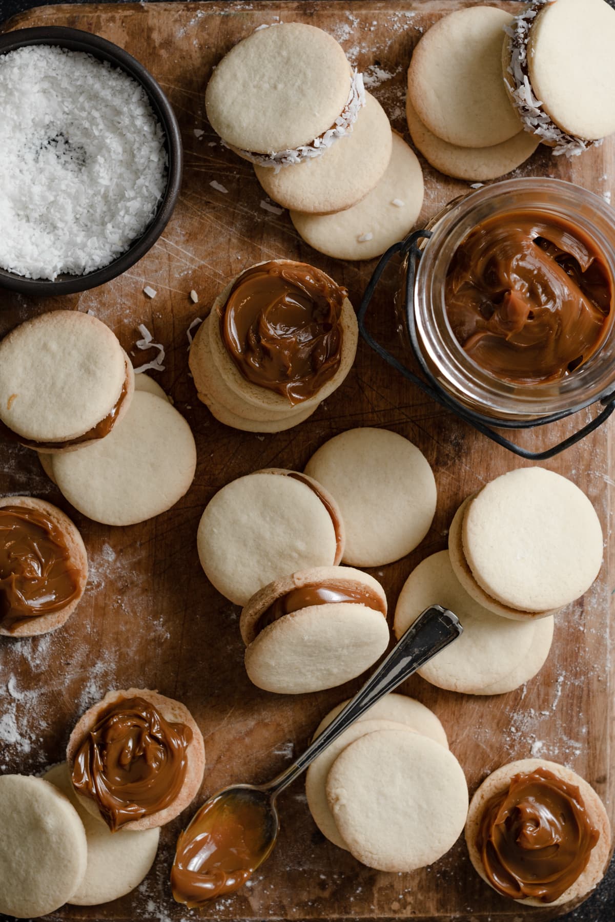 Alfajores Cookies {Dulce de Leche Sandwich Cookies} Filling alfajores cookies with dulce de leche.