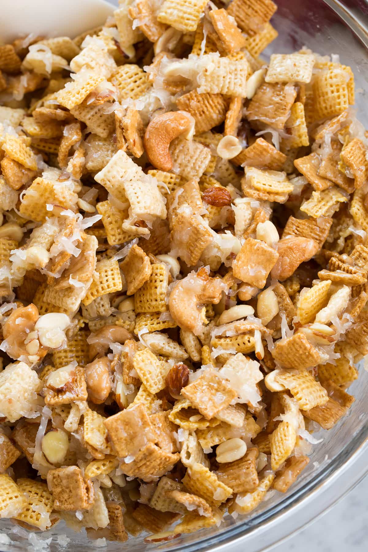 Sweet Holiday Chex Mix Overhead image of chex mix in a glass bowl.