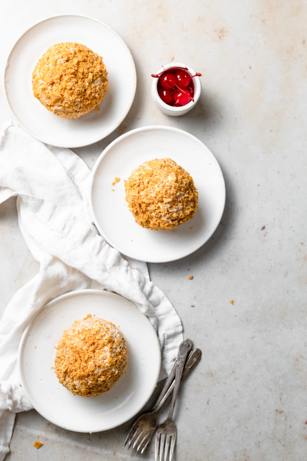 BEST EVER Easy Fried Ice Cream! Three fried ice cream balls on a white dessert plates.