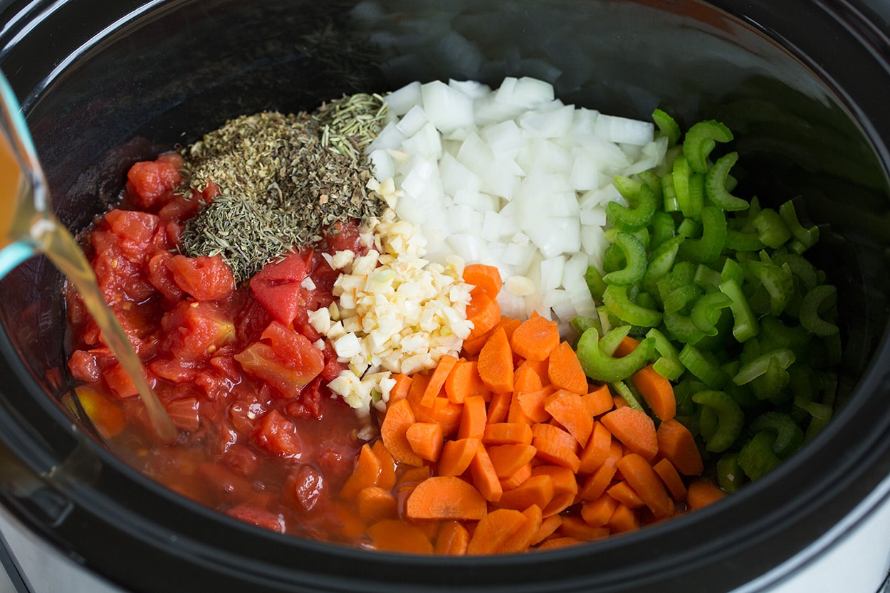 Minestrone Soup Showing how to make minestrone soup. Adding vegetables to crockpot along with broth.