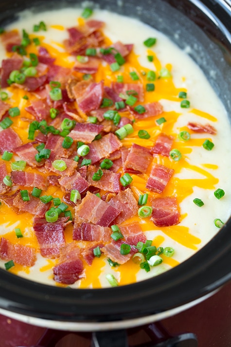 This comforting slow cooker loaded potato soup is perfect on those chilly winter nights. So easy to prepare and full of flavor! #cookingclassy #soup #potato #slowcooker A close up of Slow Cooker Loaded Potato Soup