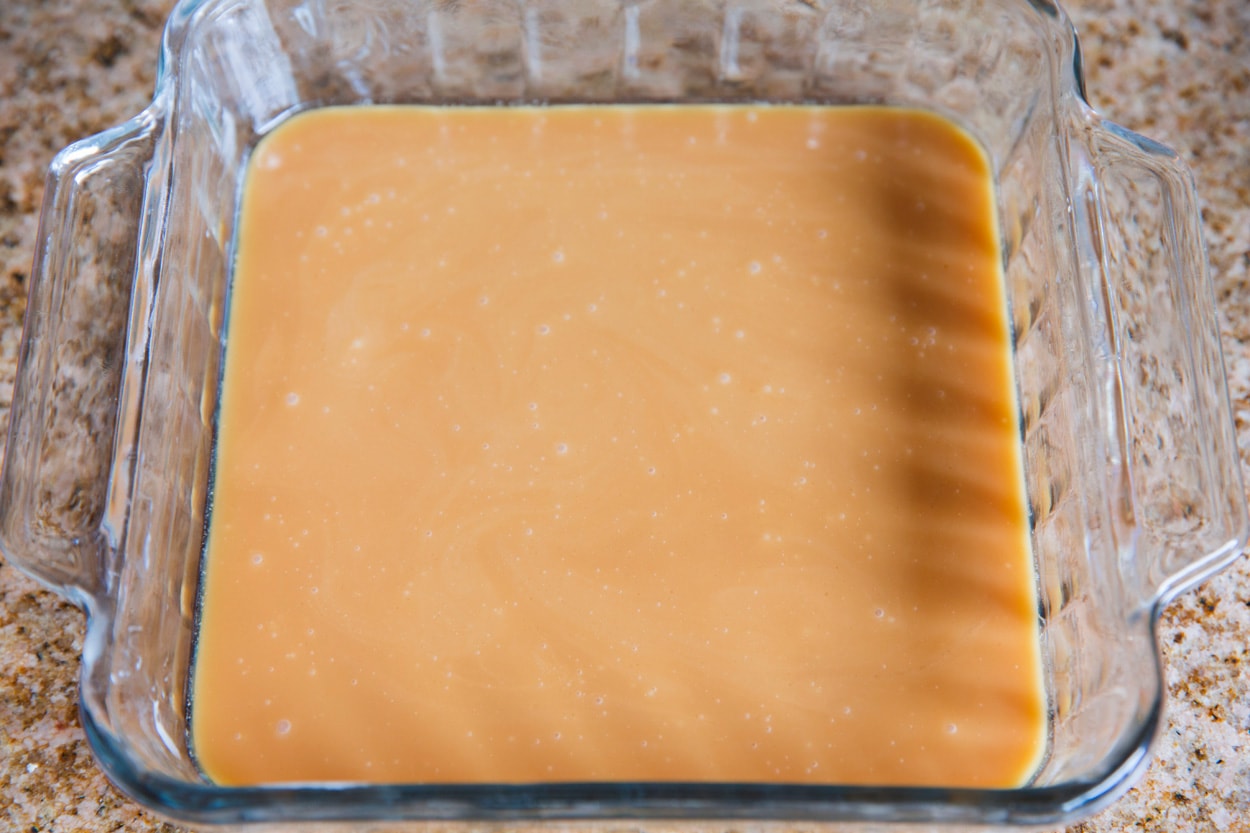 Microwave Caramels Caramel mixture poured into buttered glass baking dish.