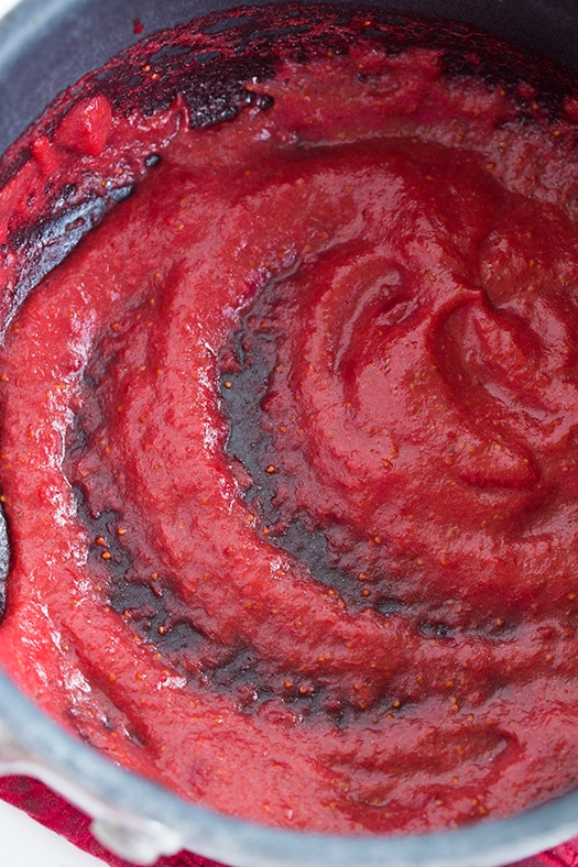 These Strawberry Cupcakes are made with chunks of fresh strawberries in the cake batter and are topped with a luscious pink Strawberry Buttercream Frosting. Bursting with flavor, these cupcakes would go down a treat at any celebration! #cookingclassy #cupcakes #strawberry #buttercream #cakes making strawberry reduction in a pan