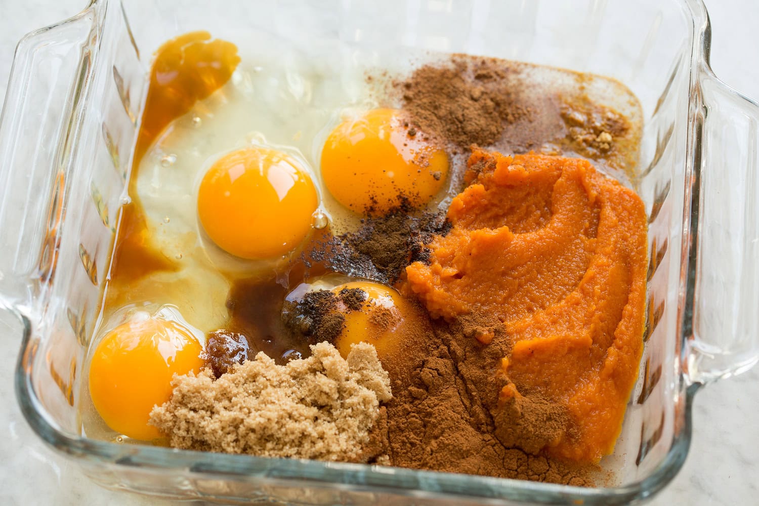 Pumpkin French Toast Pumpkin, eggs, spices, sugar in a glass dish shown before mixing.