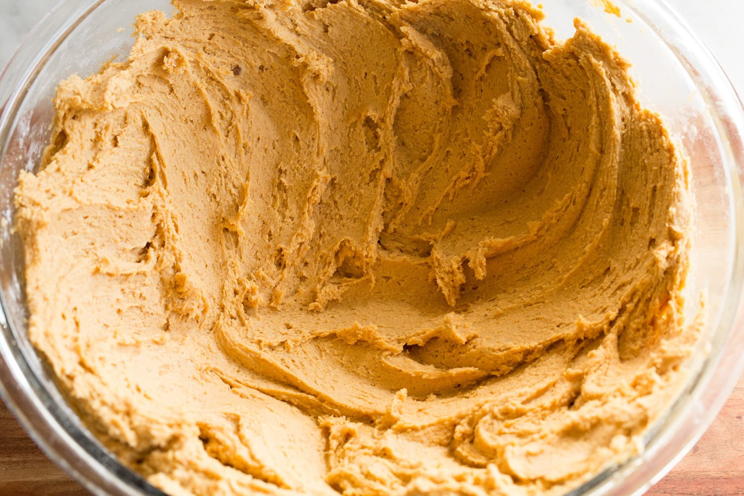 Pumpkin Snickerdoodle Cookies Pumpkin cookie dough spread out in bowl to chill evenly.