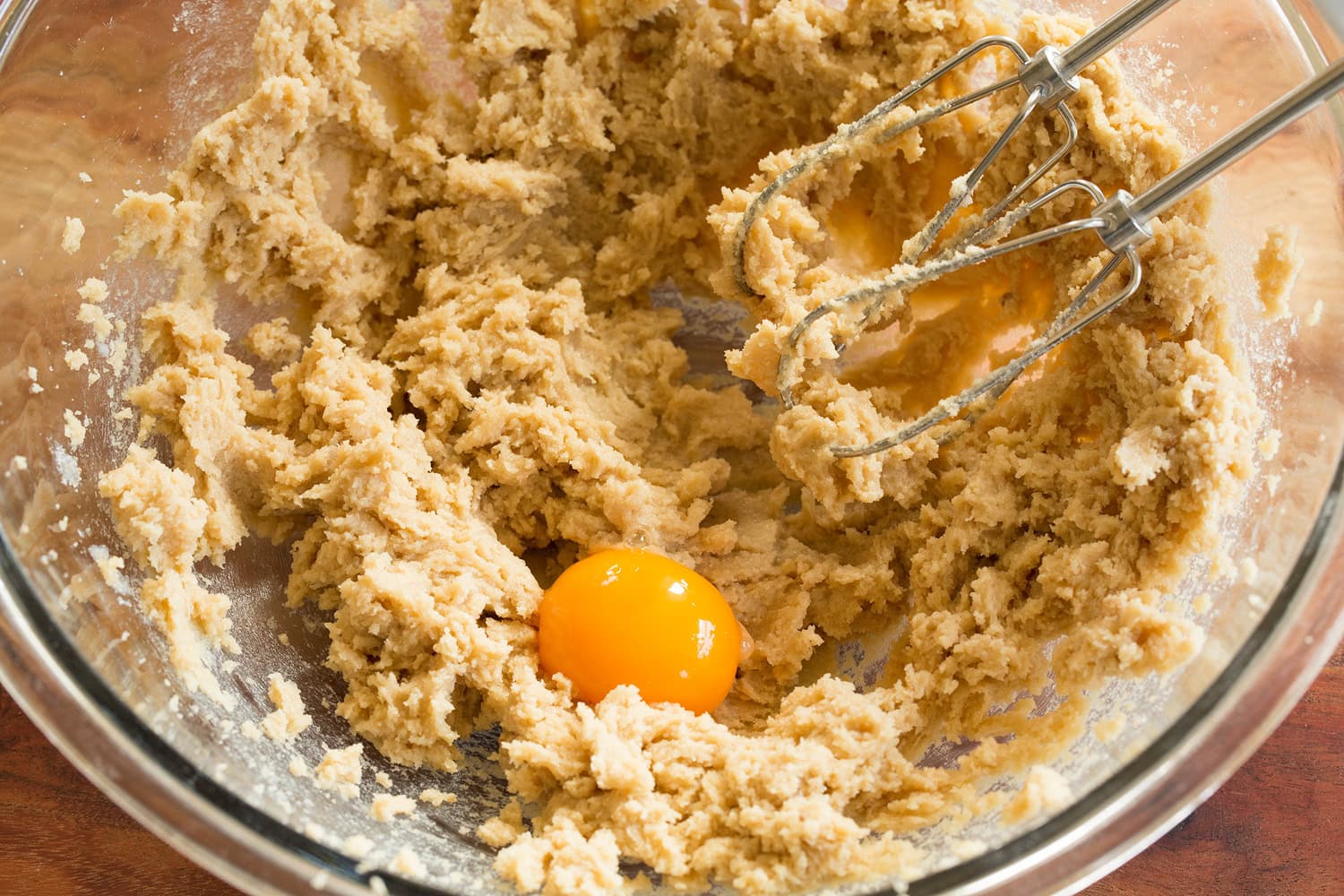 Pumpkin Snickerdoodle Cookies Creamed butter in bowl with egg yolk added.
