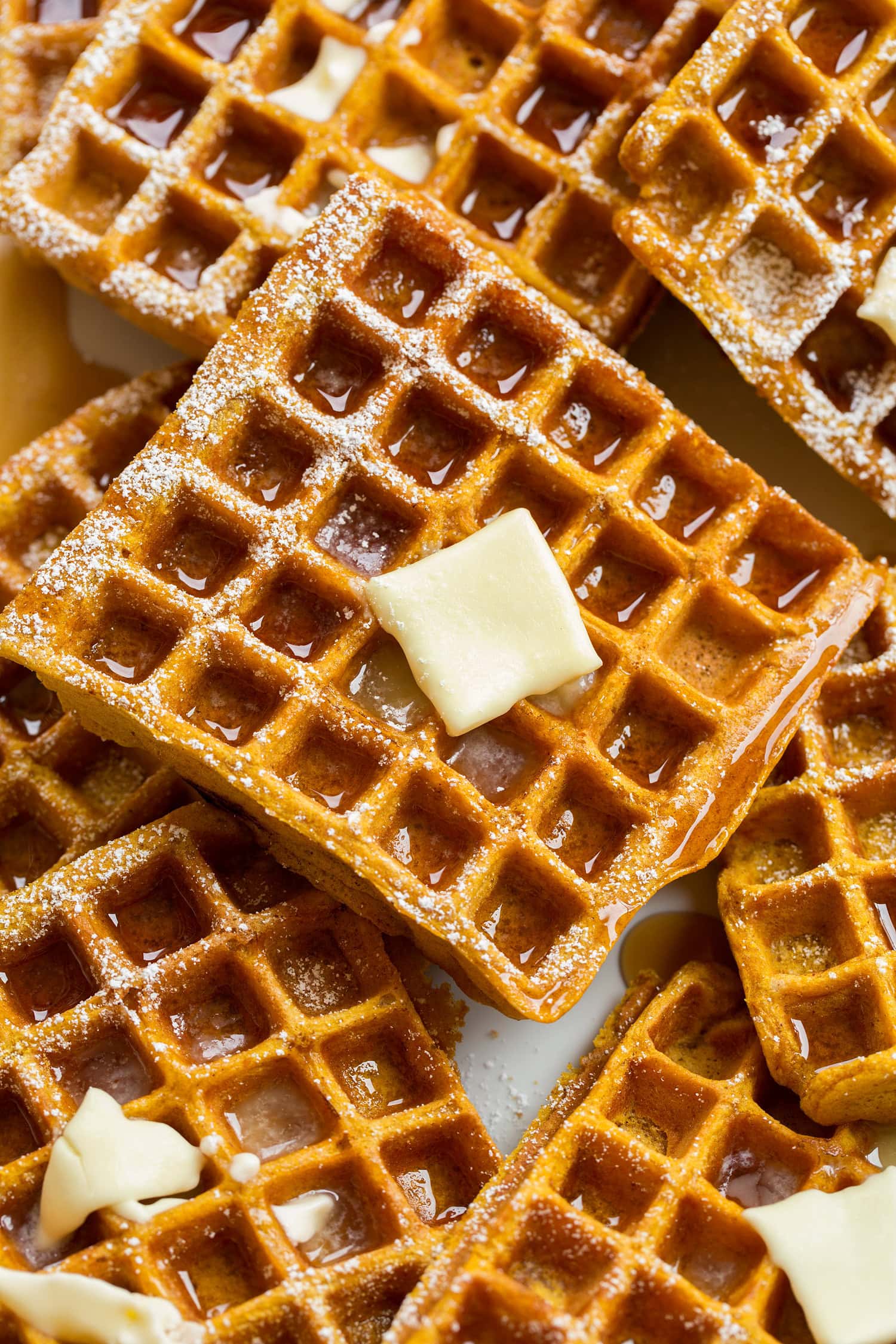 Pumpkin Waffles Close up photo of pumpkin waffle with syrup and butter.