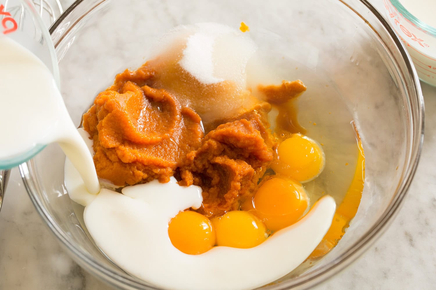 Pumpkin Waffles Egg, pumpkin, sugar, milk mixture in a mixing bowl shown before mixed.