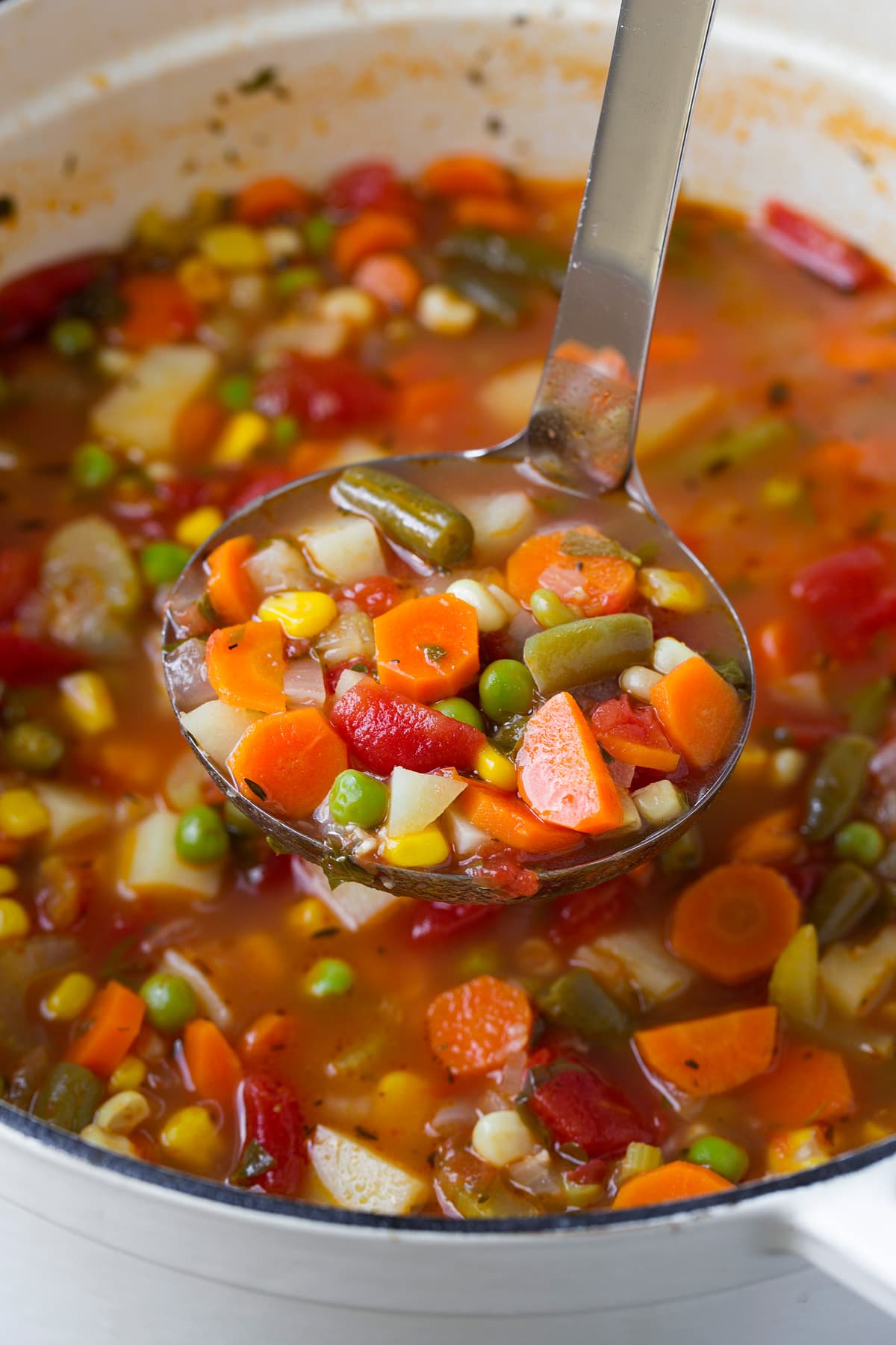 Vegetable Soup Ladle full of homemade healthy vegetable soup.