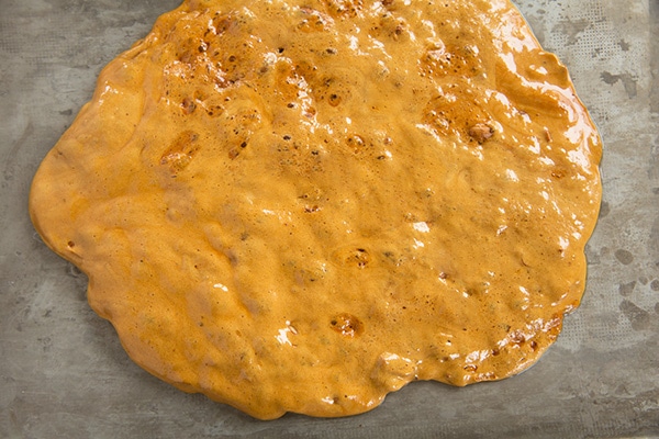 Microwave Peanut Brittle Spreading finished peanut brittle mixture onto baking sheet.
