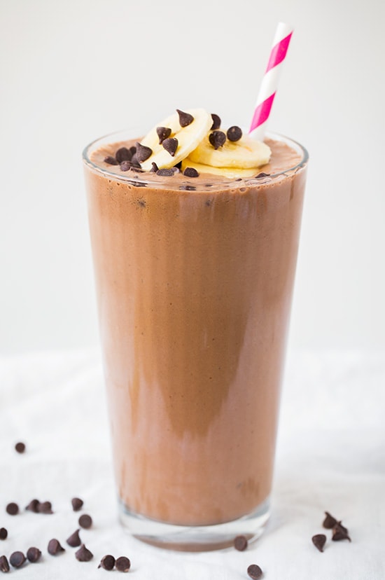 Chocolate Peanut Butter Banana Shake. This banana shake is not only delicious but healthy and so easy to whip up on busy mornings. It's made with simple ingredients and tastes incredible! | Healthy Breakfast Shake | Healthy Banana Shake | #cookingclassy #shakes #banana #chocolate A chocolate banana shake in a glass topped with slices of banana and chocolate chips