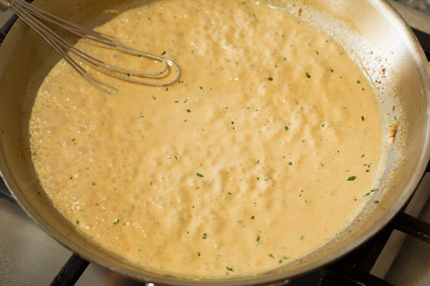 Creamy Dijon Mustard Chicken Mixed finished creamy mustard sauce shown in skillet.