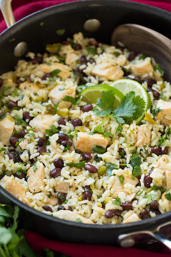 This One Pan Cilantro Lime Chicken is so easy to prepare and is packed with flavor. It's served with black beans and rice making it a filling and satisfying meal as it is but you could also go all out and add your favorite Mexican toppings. #cookingclassy #chicken #lime #onepan A close up of One Pan Cilantro Lime Chicken and Rice with Black Beans