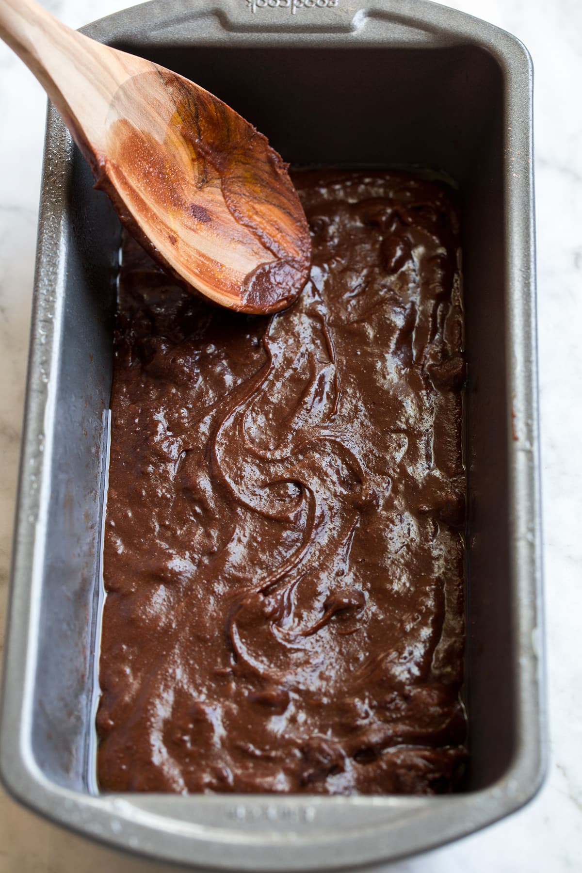 Small Batch Brownies Brownie batter being spread into a bread pan.