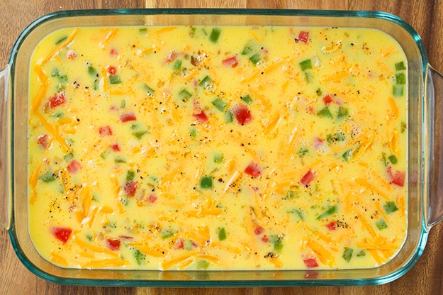 uncooked denver omelet in glass baking dish