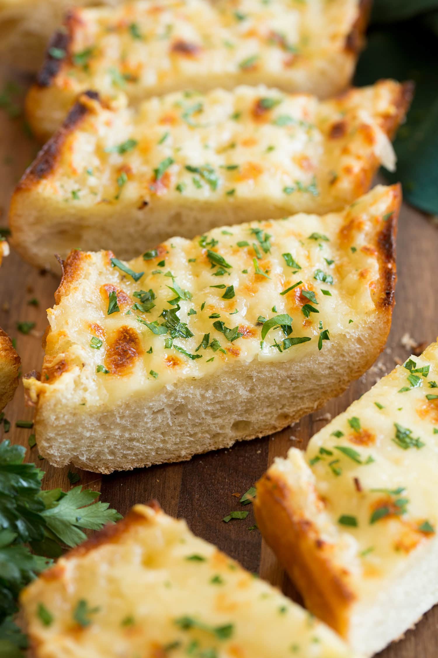 Cheesy Garlic Bread Close up photo of slice of garlic bread with cheese.