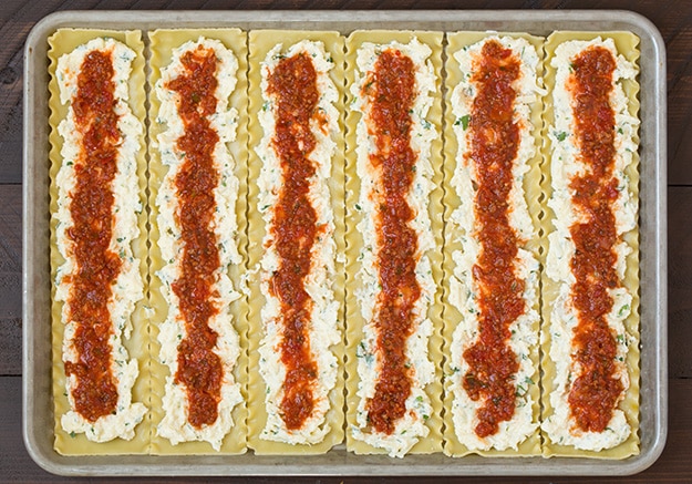 Lasagna Roll Ups. Not only look incredible but taste incredible. There's served in individual portions and are great for freezing too. | Lasagna Recipes | Easy Lasagna | #cookingclassy #lasagna #pasta #rollups Tomato sauce spread on pasta for making lasagna roll ups