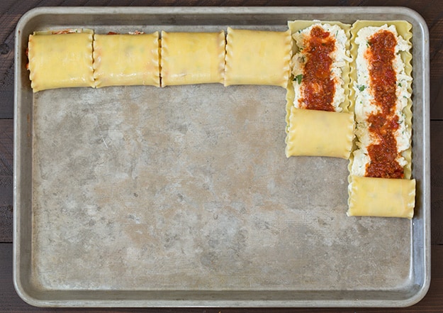 Lasagna Roll Ups. Not only look incredible but taste incredible. There's served in individual portions and are great for freezing too. | Lasagna Recipes | Easy Lasagna | #cookingclassy #lasagna #pasta #rollups Lasagna Roll Ups on a baking tray getting rolled up