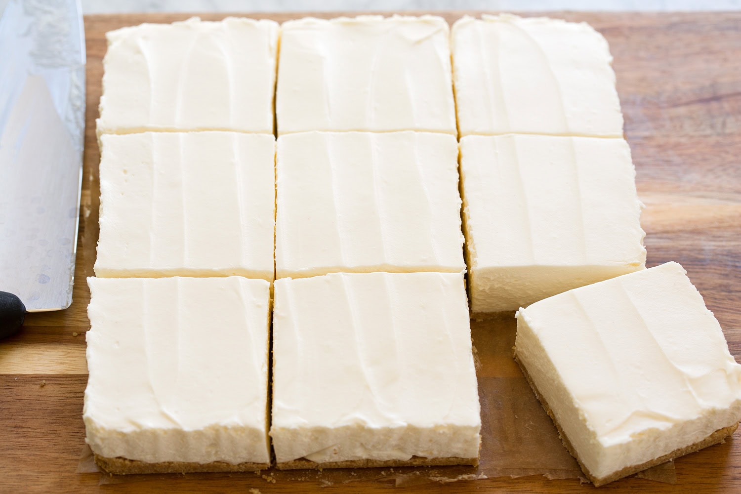 No Bake Cheesecake Cheesecake bars shown after chilled and set, and sliced.