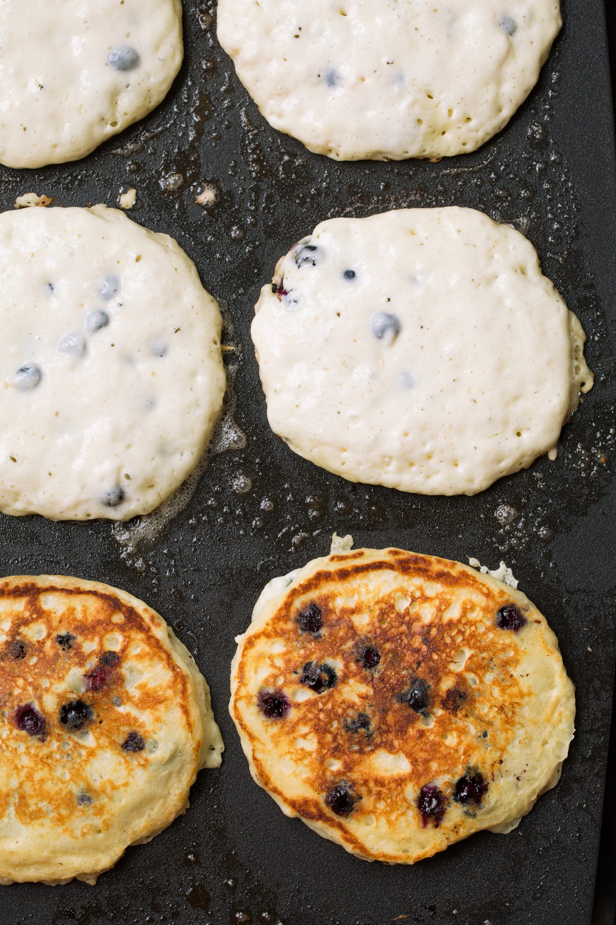 Blueberry Pancakes Showing how to cook blueberry pancakes on a griddle.
