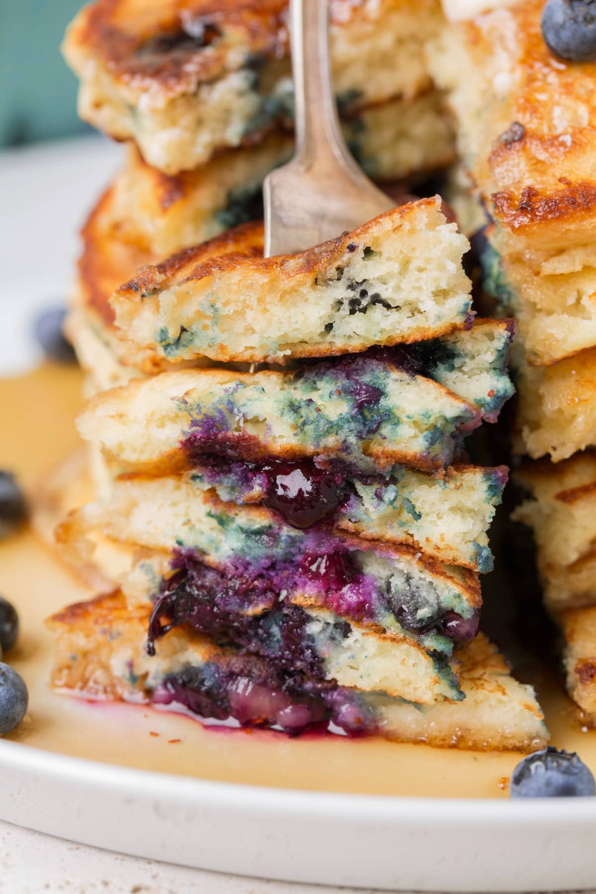 Blueberry Pancakes Stack of pancakes cut into, showing close up.