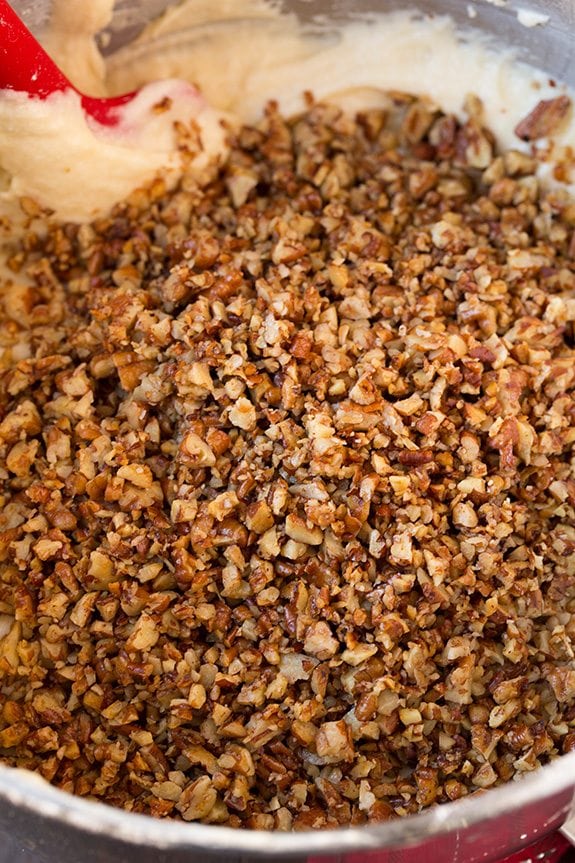 Butter Pecan Cake Chopped pecans added to butter pecan cake batter in mixing bowl.