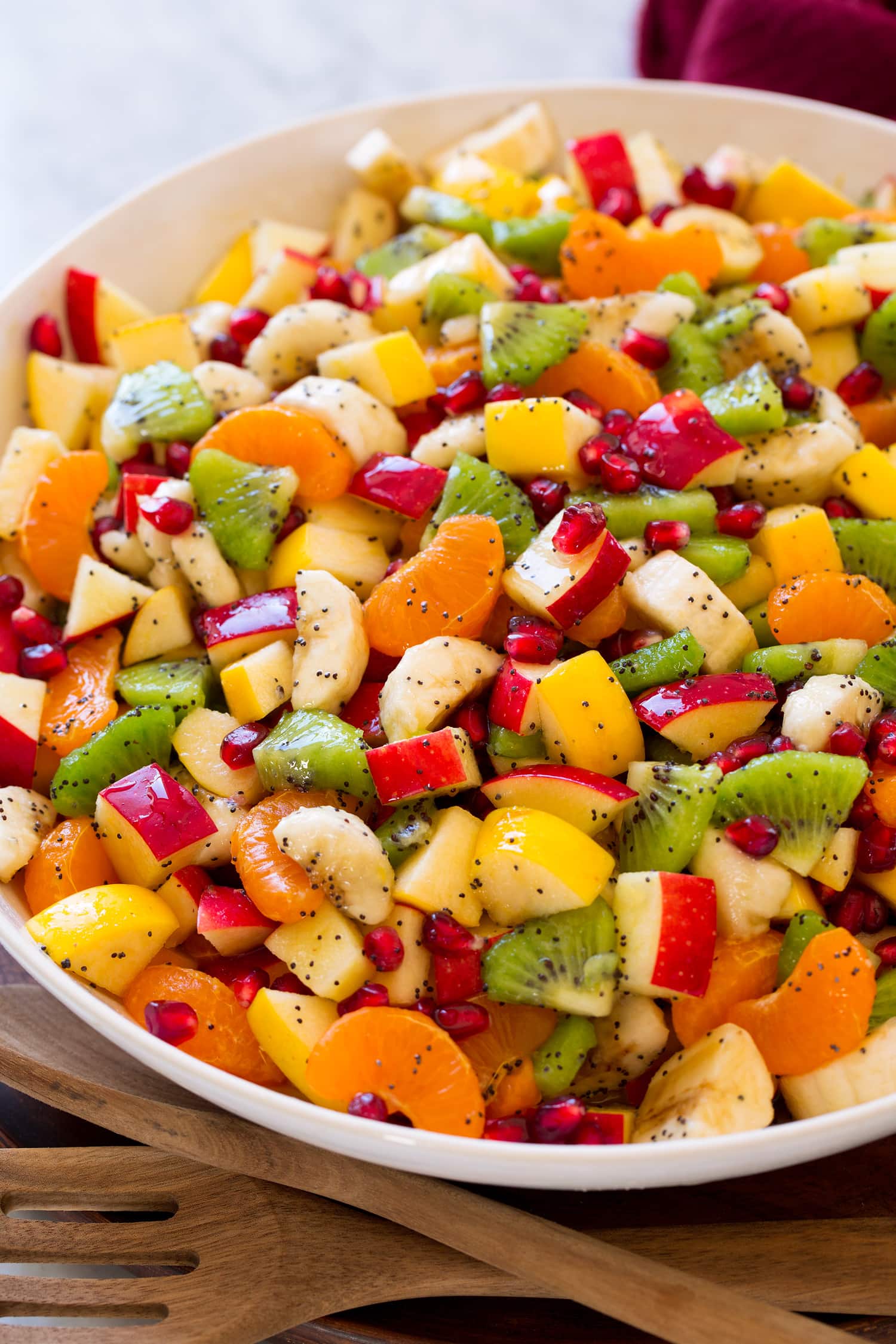Winter Fruit Salad Close up of completed winter fruit salad showing apples, kiwis, oranges, pomegranate, and bananas.