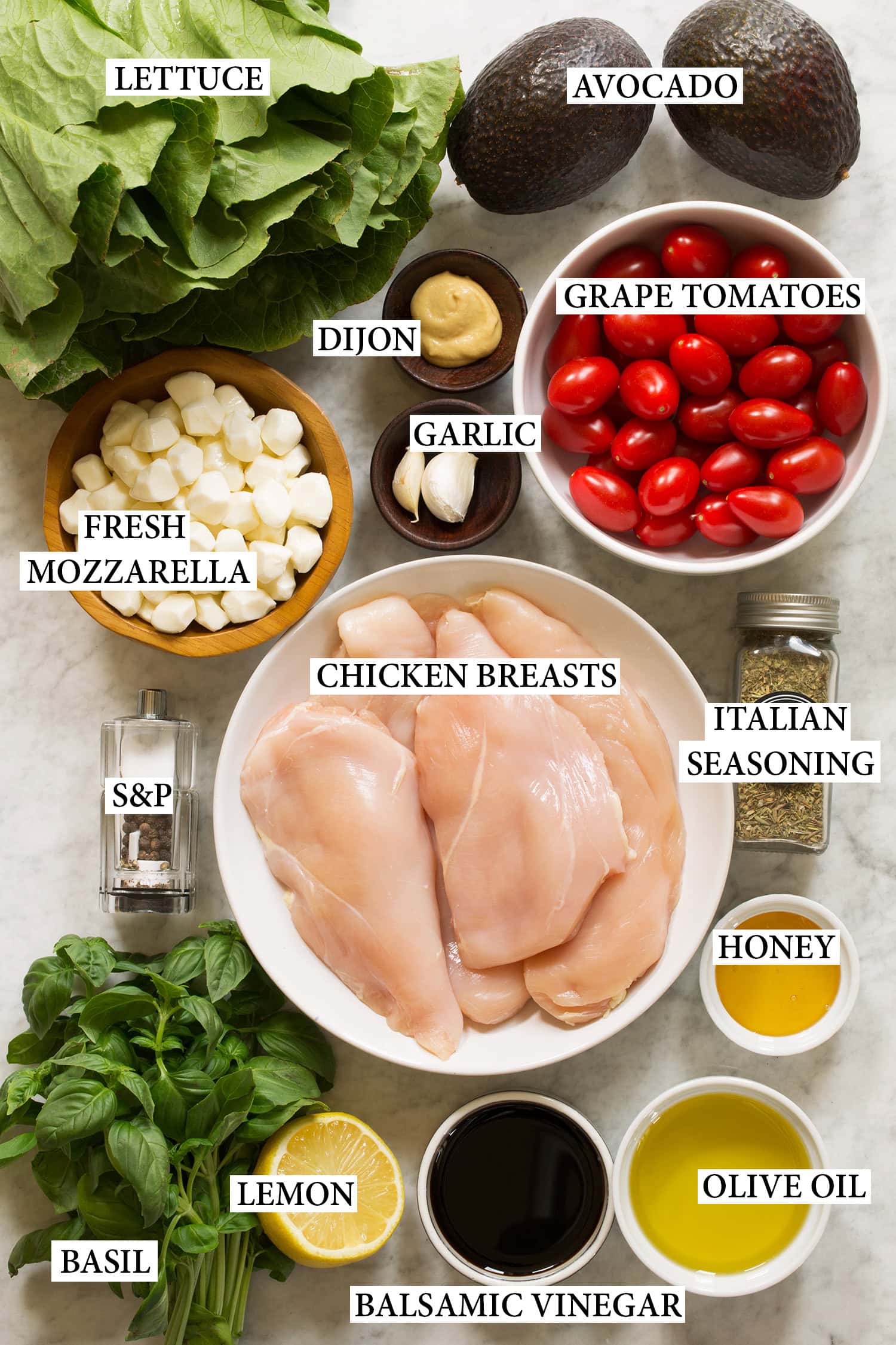 Caprese Chopped Salad Ingredients used to make chicken chopped salad shown in bowls with lables.