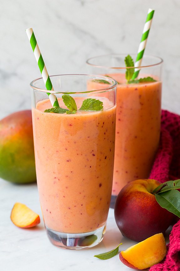 Mango Peach Strawberry Smoothie | Cooking Classy two glasses of mango strawberry peach smoothies with striped straws