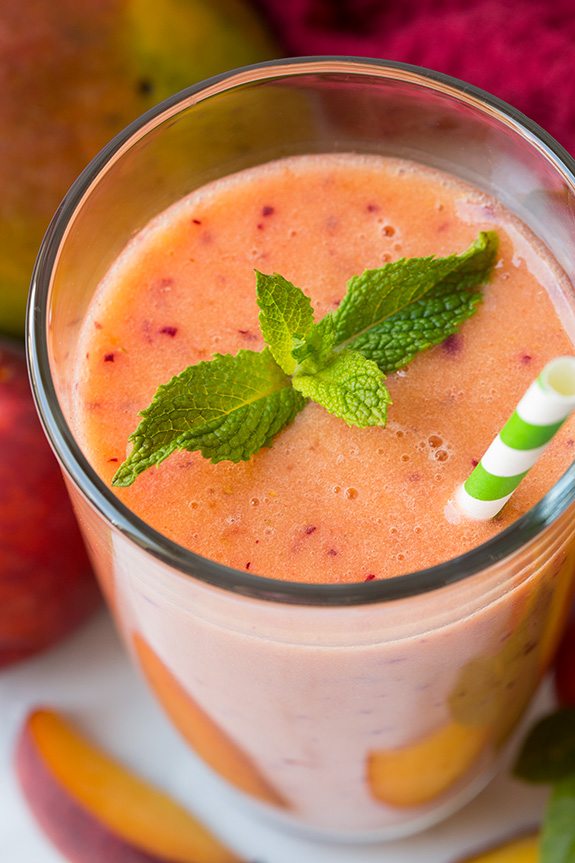 Mango Peach Strawberry Smoothie | Cooking Classy Frozen mango peach Smoothie in Glass With Straw