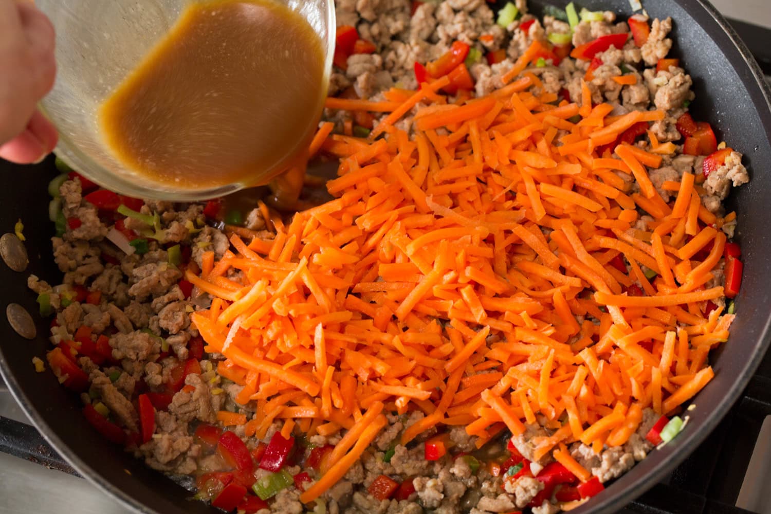 Thai Chicken Lettuce Wraps Carrots added to the ground meat mixture in the skillet.