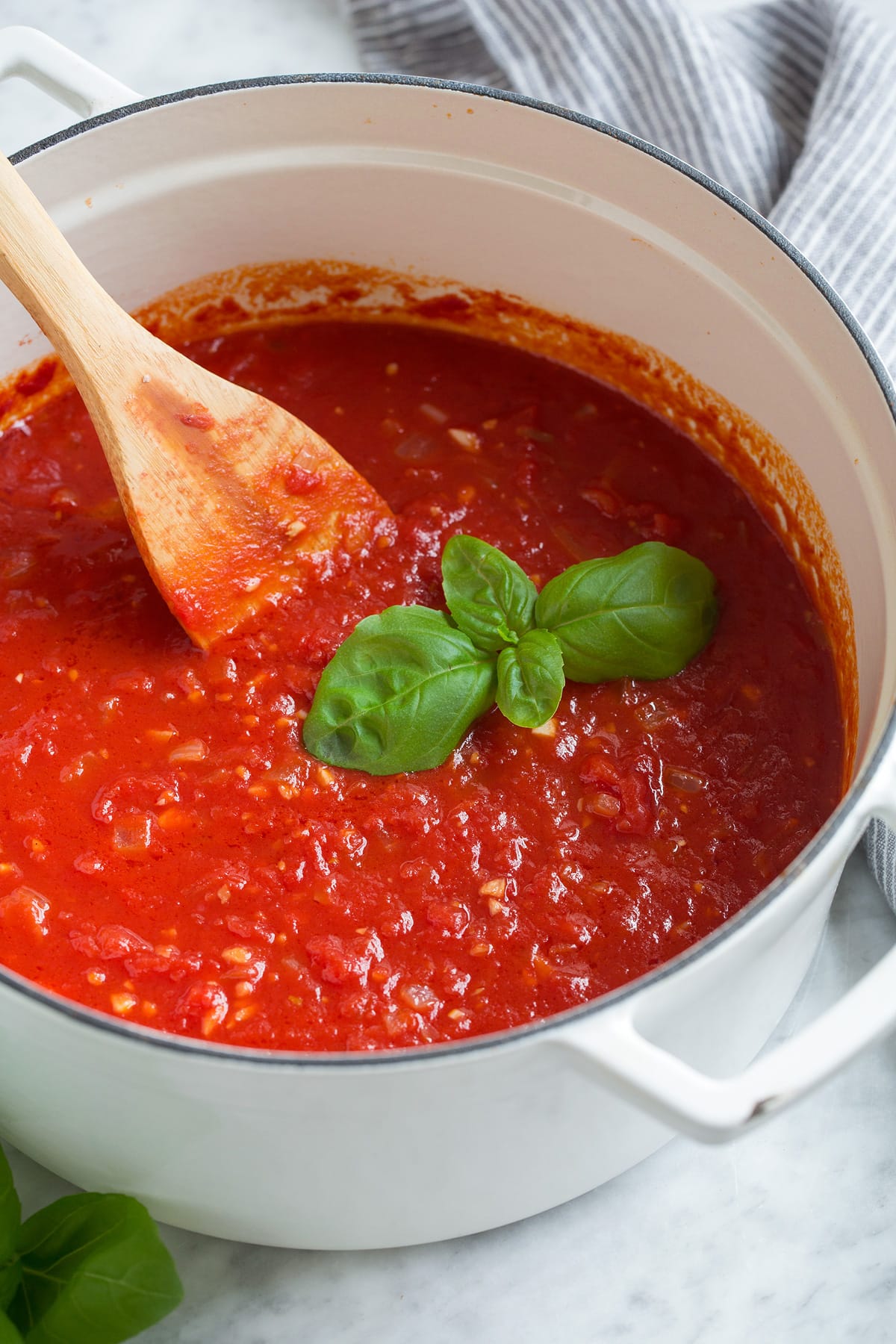 Homemade Marinara Sauce - so much better than the bottled stuff! This is authentic, fresh tasting sauce that you'll want to make again and again! Perfect over just about any type of pasta or served with cheese tortellini. It freezes really well too! #marinara #sauce #recipe #italianfood #dinner #lunch Marinara sauce in a pot after simmered.