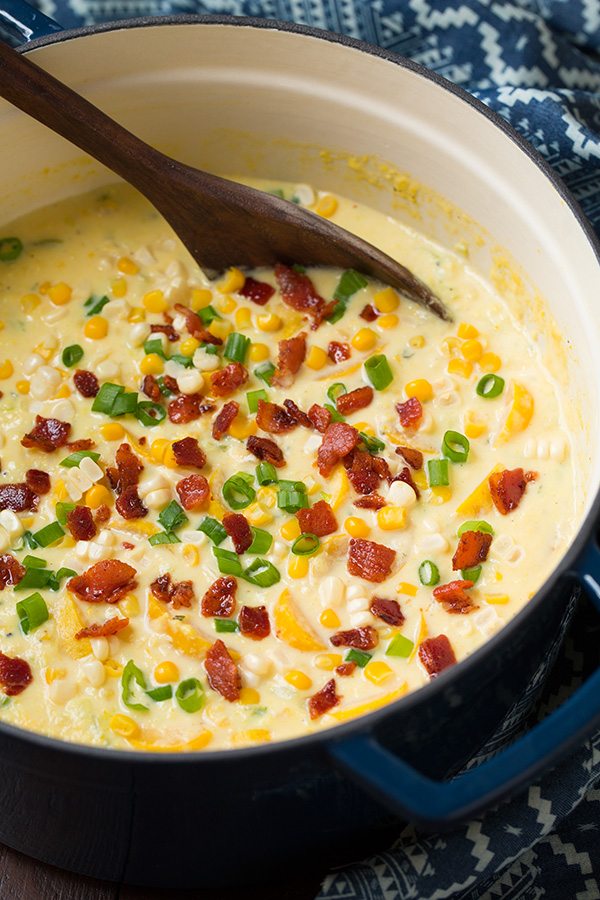 Summer Squash and Corn Chowder Summer Squash and Corn Chowder in a blue pot with a wooden ladle.