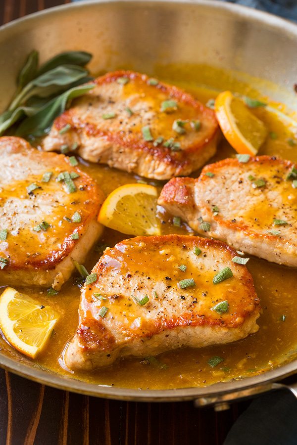 Orange Sage Pork Chops Boneless pork chops in skillet with orange and herb sauce.