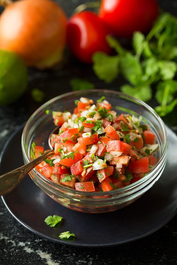 Chicken Tostadas With Beans and Avocado Pico de gallo in a small glass bowl for tostadas