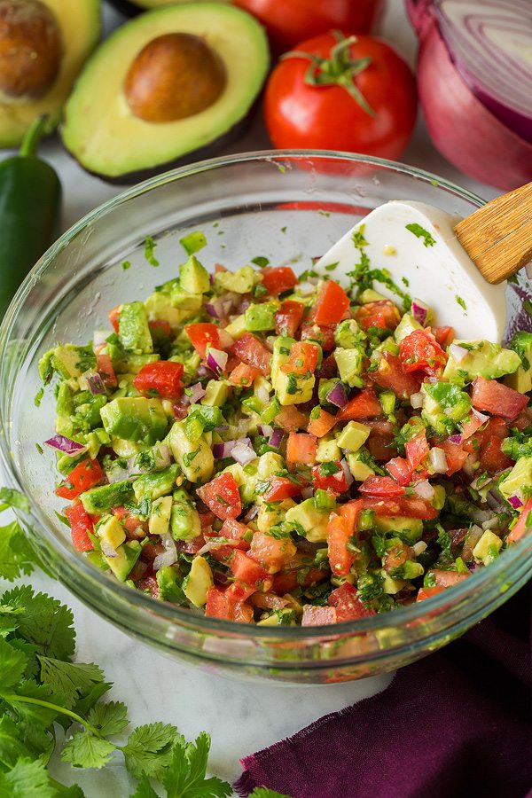 Grilled Chicken Burrito and Quinoa Bowls with Avocado Salsa | Cooking Classy Avocado salsa in a mixing bowl for burrito bowls.