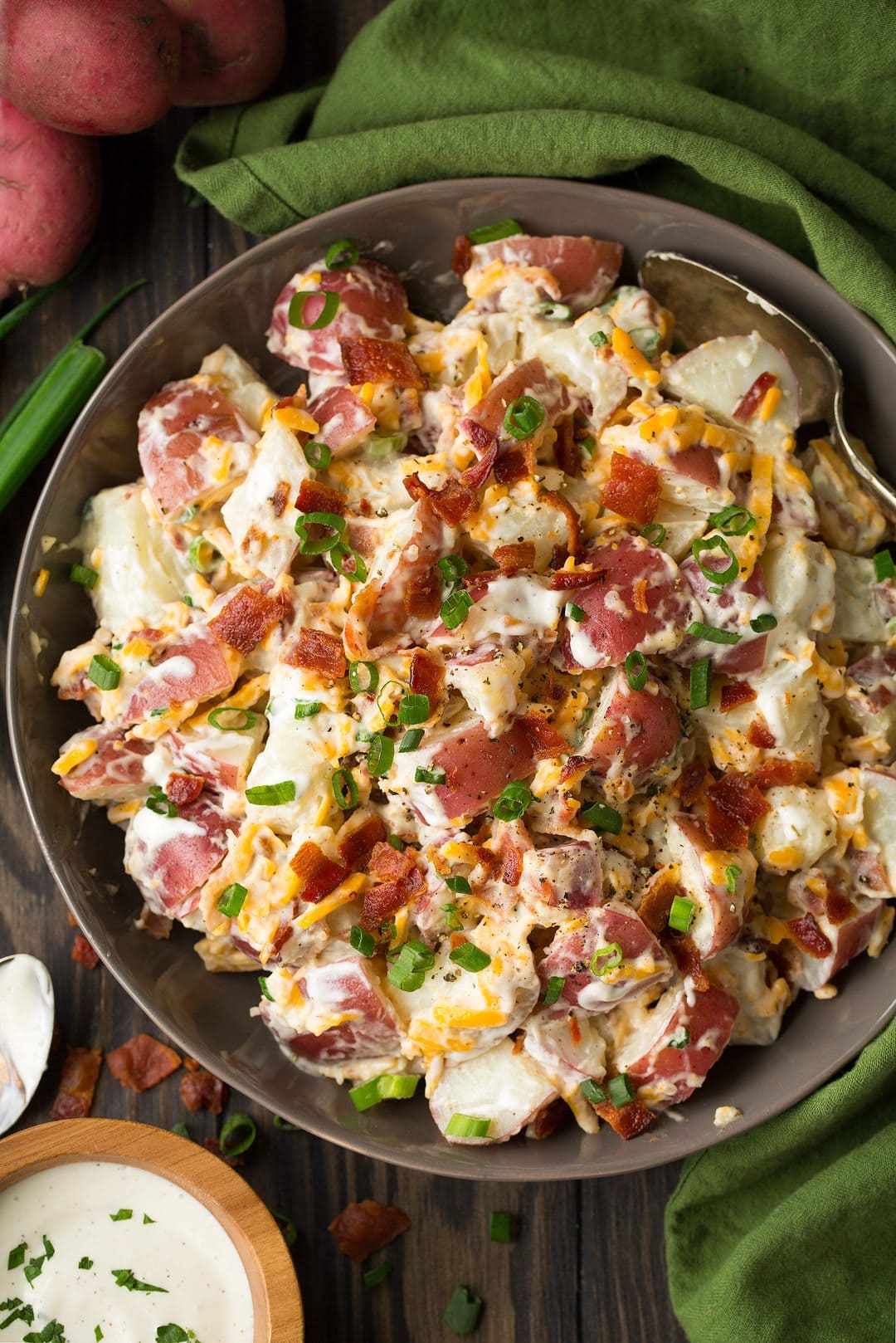 bowl of cheddar bacon ranch potato salad on a green towel