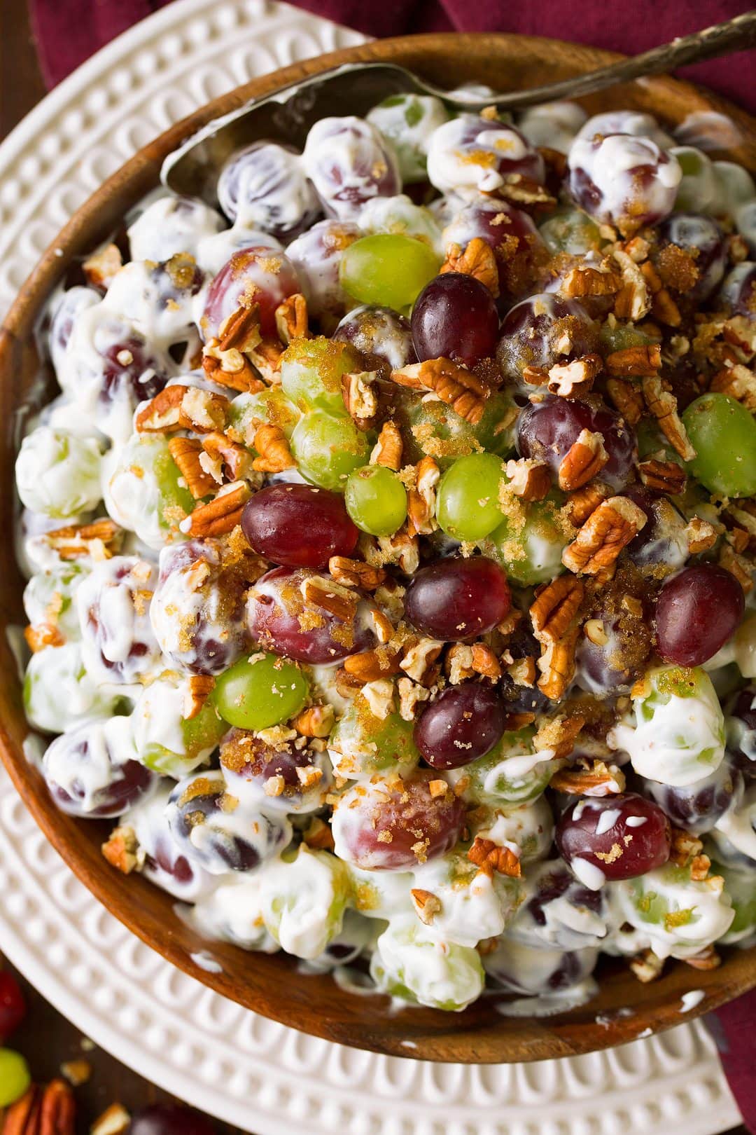 Grape Salad Recipe Overhead close up image of grape salad in a large wooden bowl.