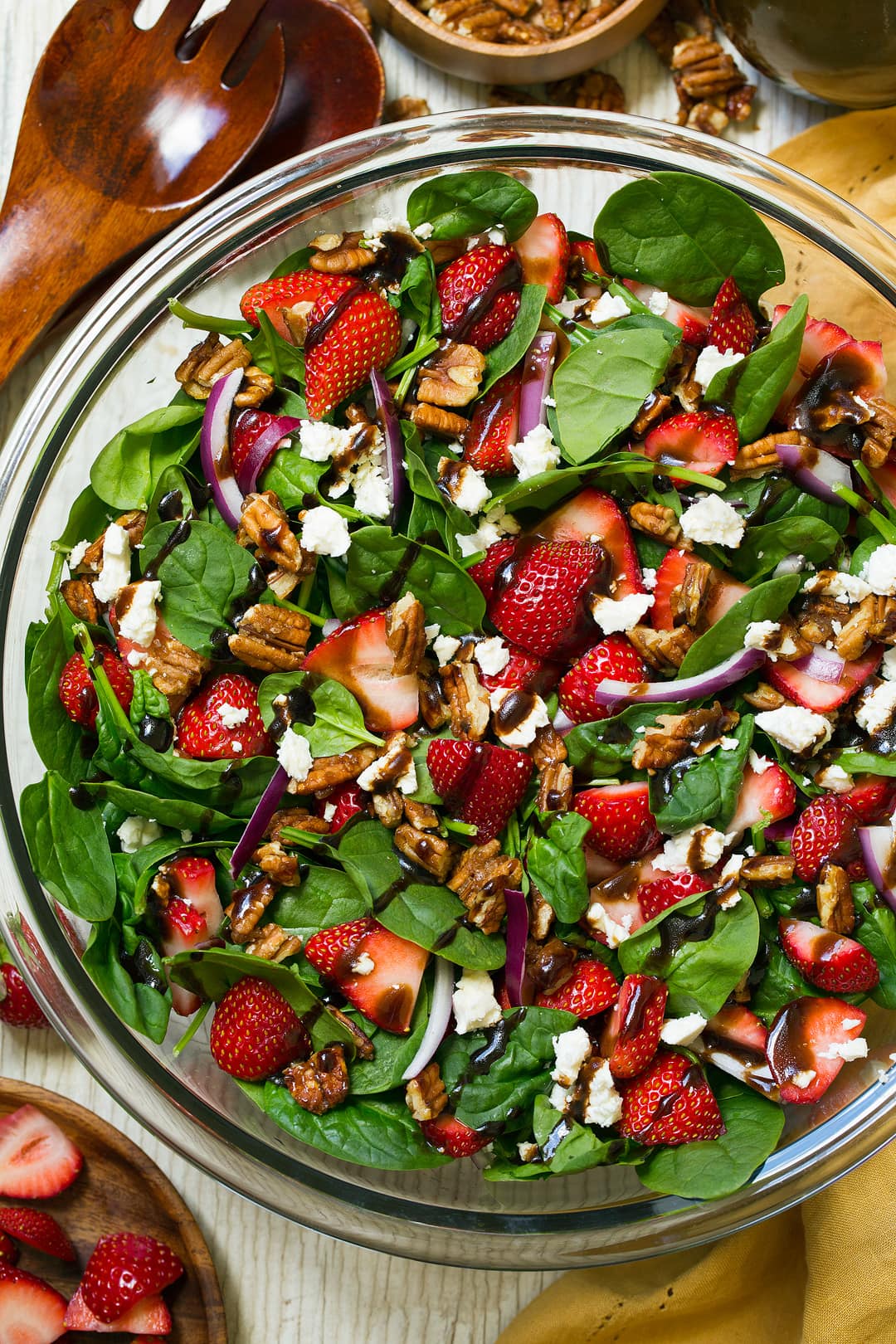 Strawberry Spinach Salad. An easy and delicious spinach salad made with strawberries, feta, candied pecans and a balsamic vinaigrette. | Strawberry Salad | Summer Salads | Easy Salads | #cookingclassy #spinach #strawberry #salad Strawberry Spinach Salad in a glass bowl with a balsamic dressing