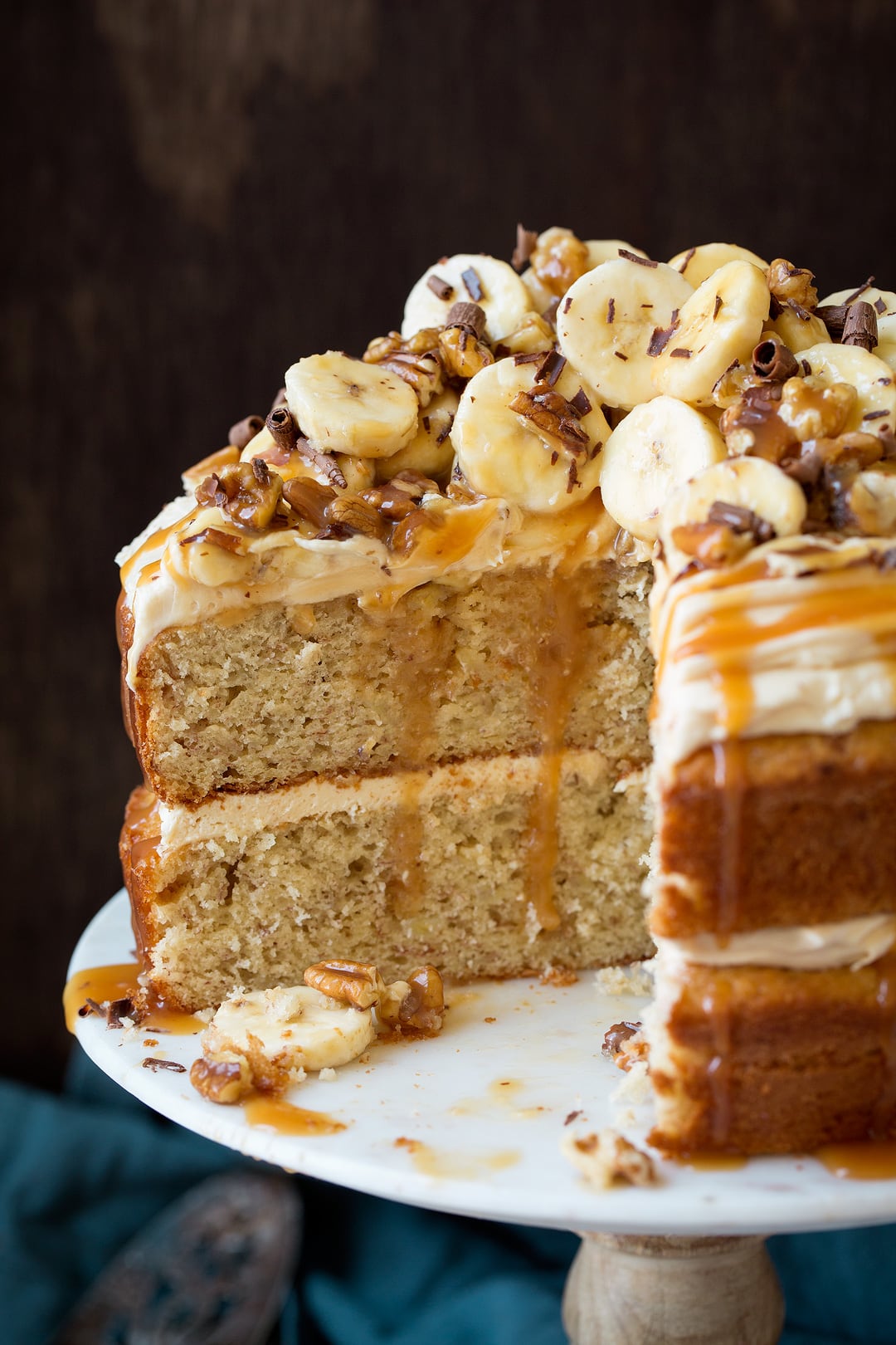 Banana Cake Close up image of sliced banana cake sitting on marble cake stand.