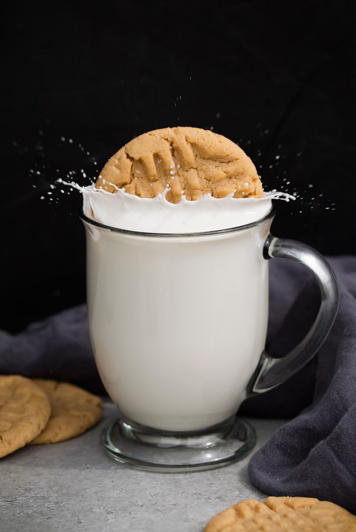 Peanut Butter Cookies Peanut Butter Cookies dropped in milk and splashing.