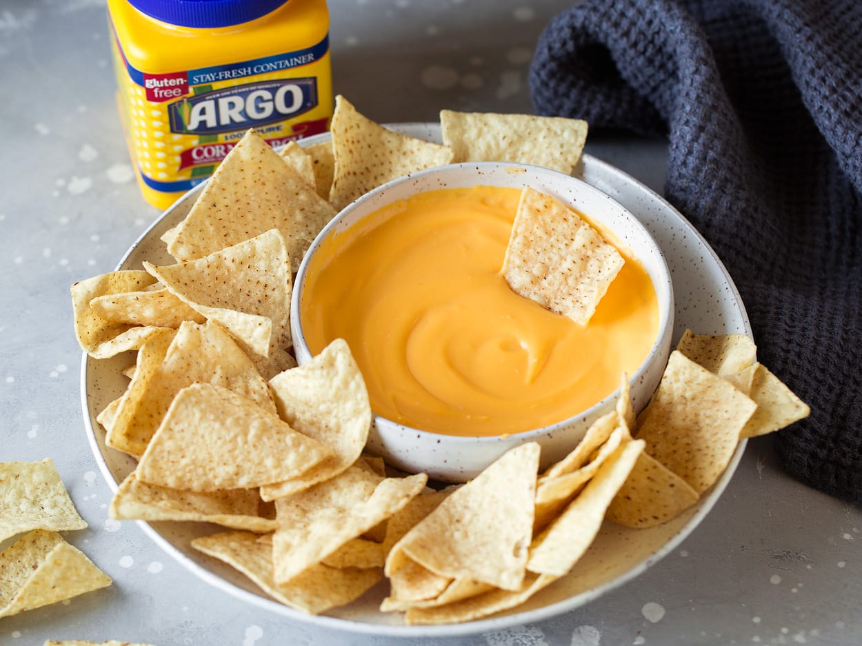3 Ingredient Cheese Dip bowl of cheese dip on plate with tortilla chips
