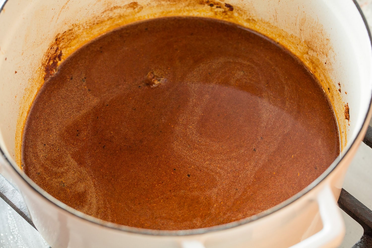 Shredded Beef Tacos Chili seasonings and broth in a large pot.