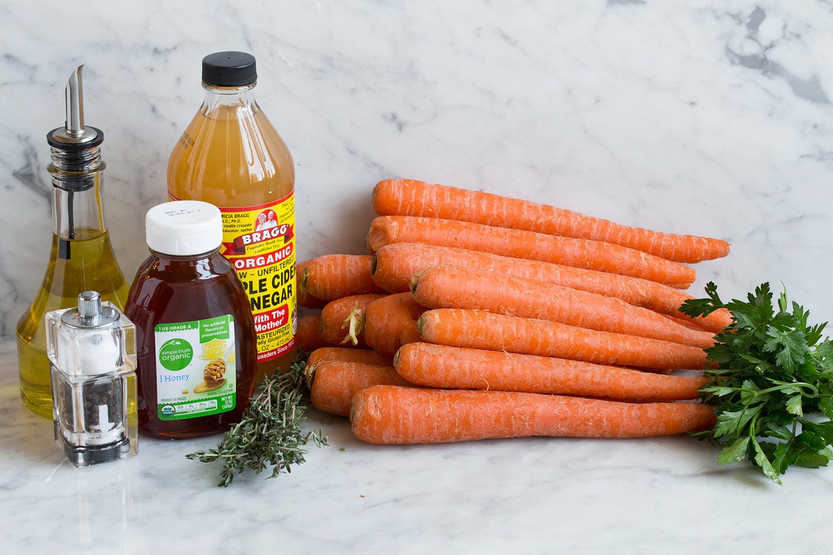 Roasted Carrots Photo: Shows carrots, parsley, apple cider vinegar, honey, thyme, olive oil, salt and pepper. These are ingredients used to make roasted carrots.