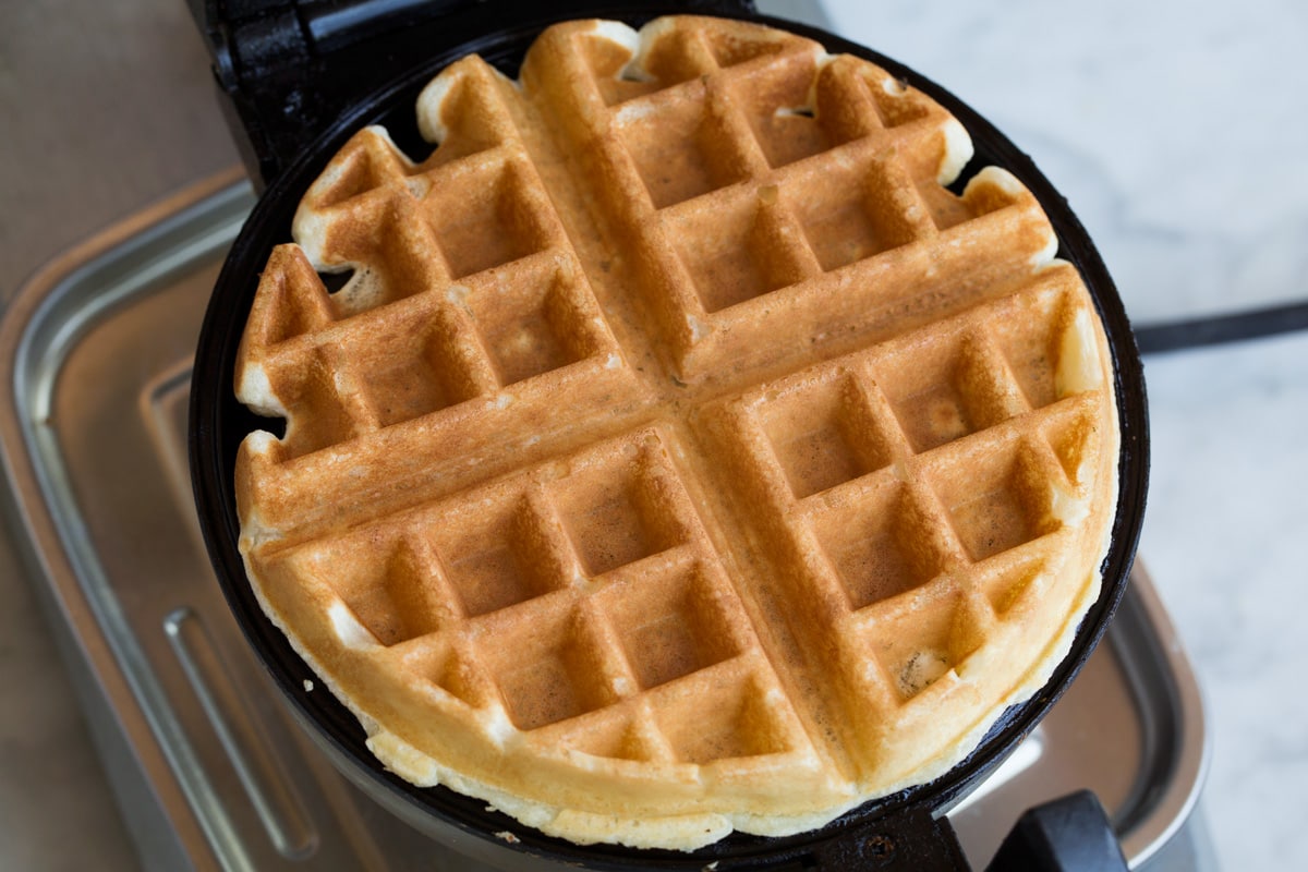 How to Make Perfect Belgian Waffles - with step by step instructions! These are easily the best waffles you'll try! Light and fluffy and tender inside and deliciously crisp outside. #belgian #waffles #breakfast Belgian waffle after finished cooking on a waffle iron.