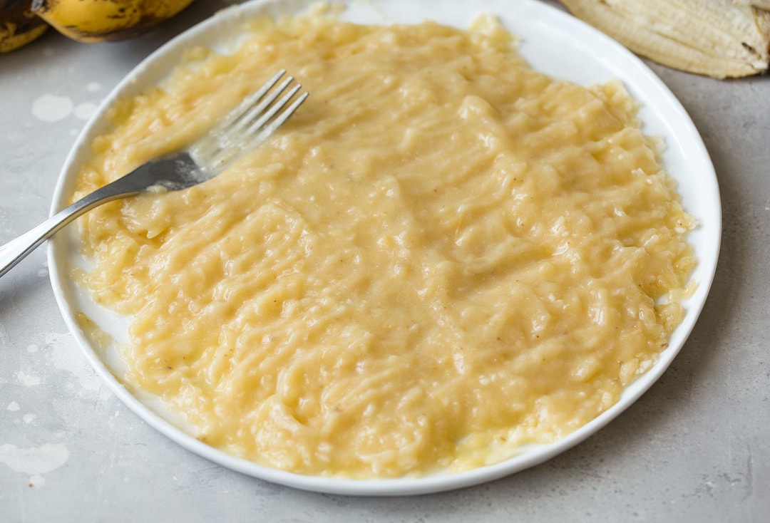 This is the best banana bread recipe! Quick and easy to make and no mixer is required. It's perfectly moist and amazingly tender and it's brimming with banana flavor. Simply put, everyone will have a hard time stopping at just one slice! #cookingclassy #banana #bread #bananabread well mashed bananas for banana bread on a plate