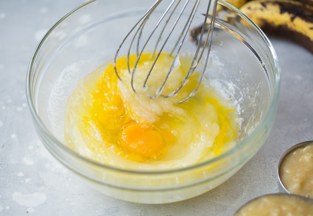 This is the best banana bread recipe! Quick and easy to make and no mixer is required. It's perfectly moist and amazingly tender and it's brimming with banana flavor. Simply put, everyone will have a hard time stopping at just one slice! #cookingclassy #banana #bread #bananabread eggs in banana bread mixture in a glass bowl