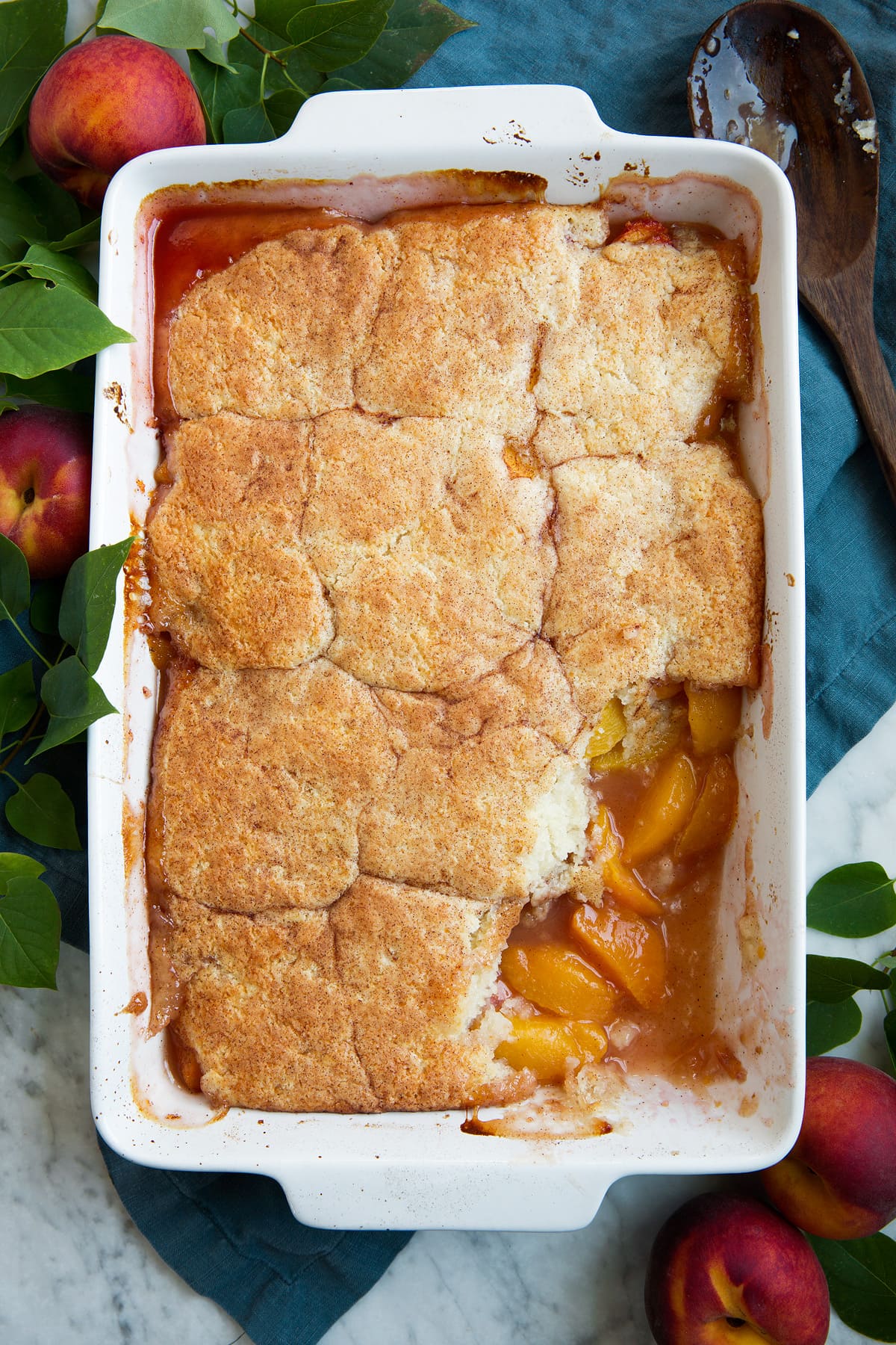 Peach Cobbler - the only peach cobbler recipe you'll ever need! I've never found better! Light and fluffy, buttery topping and perfectly sweet and juicy peach filling. #peach #cobbler #dessert #recipe Whole pan of peach cobbler.