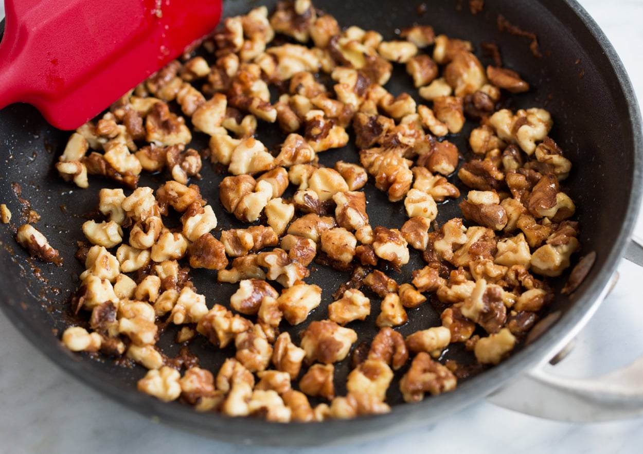 Pear Salad Making candied walnuts in skillet with brown sugar and butter for Pear Salad with